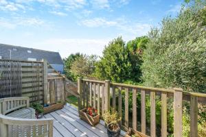 a wooden deck with a bench and some plants at 2 Bed in Shoreham-by-Sea oc-b29920 in Shoreham-by-Sea