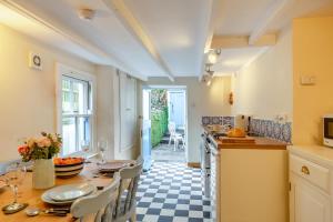 a kitchen with a table and chairs and a counter top at 2 Bed in Little Petherick oc-w28425 in Little Petherick