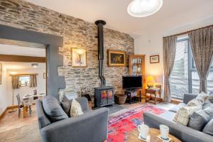 a living room with two couches and a brick wall at 1 Bed in Windermere oc-f31665 in Crook +11 photos