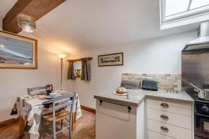 a kitchen with a table and a counter top at 1 Bed in Windermere oc-f31665 in Crook