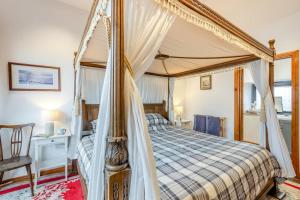 a bedroom with a canopy bed and a chair at 1 Bed in Windermere oc-f31665 in Crook