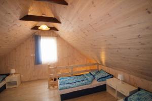 a bedroom in a log cabin with two bunk beds at Morska Przygoda in Rewal