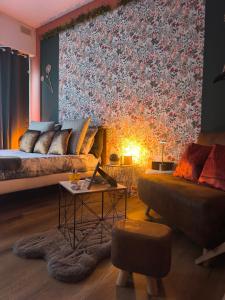 a living room with a bed and a couch at Appart cosy proche plage in Calais