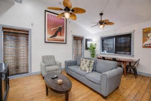 a living room with a couch and a table at Pescado Penthouse in Key West