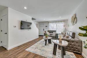 a living room with a couch and a tv at 1 Mi to MGM Springfield: Cozy Winter Duplex! in Springfield