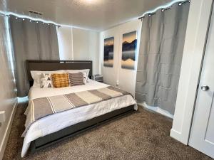 a bedroom with a bed and a shower at Sun & Snow Bungalow Remodeled Hot Tub W&D in South Salt Lake