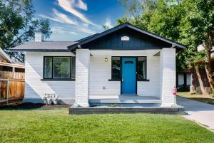 a white house with a blue door at Sun & Snow Bungalow Remodeled Hot Tub W&D in South Salt Lake