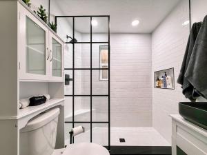 a white bathroom with a shower and a toilet at Sun & Snow Bungalow Remodeled Hot Tub W&D in South Salt Lake