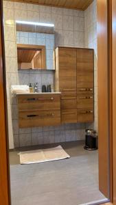 a bathroom with a dresser and a mirror at Ferienhof Hochbrandt in Spital am Pyhrn +67 photos