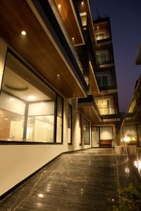 an external view of a building with large windows at Royal Raven Hotel & Banquet' Greater Noida Nearby India Expo Centre & Mart in Greater Noida