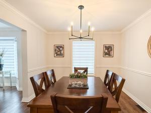 a dining room with a table and chairs at The Promenade Cottage License # 002-2023 in Niagara-on-the-Lake