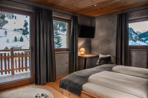 a bedroom with a bed and a view of a mountain at Naturhof eibl in Grossarl