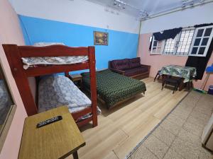 a room with two bunk beds and a couch at Casona Sol in Mar del Plata