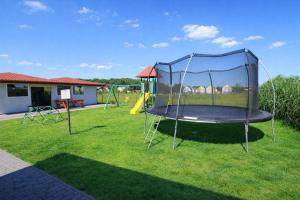 a playground with a trampoline in a yard at Morska Przygoda in Rewal