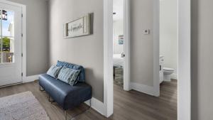 a living room with a blue chair and a bathroom at Harmony by the Bay in Santa Rosa Beach +47 photos