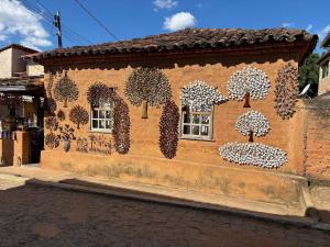 a mural of trees on the side of a building at Mountain View Guesthouse: Peaceful Retreat near Tiradentes in Prados