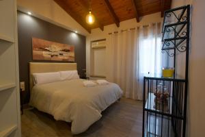 a bedroom with a bed and a window at Apartamentos Turisticos Ilusiones 2 in Cazalla de la Sierra