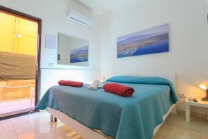 a bedroom with a bed with two red pillows on it at bed and fly near 2 fontanarossa 800mt aeroporto catania in CTA