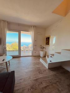 a living room with a view of the ocean at Country House Tagliaferro in Marciana Marina