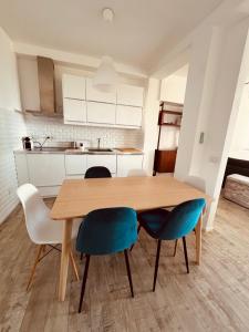 a kitchen with a wooden table and blue chairs at Country House Tagliaferro in Marciana Marina