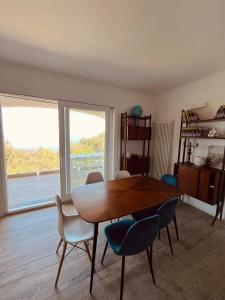 a dining room with a table and chairs and a window at Country House Tagliaferro in Marciana Marina +53 photos