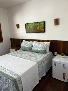 a bedroom with a bed and a picture on the wall at suite elegante fullhausi 02 in Fortim