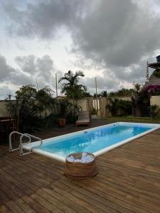 a small swimming pool on a wooden deck at suite elegante fullhausi 02 in Fortim +2 photos