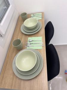a table with plates and bowls on top of it at Ap Fuenlabrada in Fuenlabrada