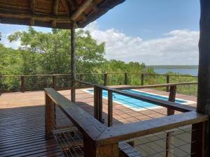 a deck with a swimming pool on top of a house at Eden Village Lodge in Chidenguele