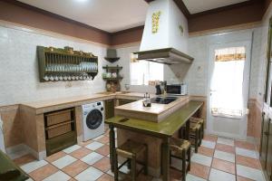a kitchen with a sink and a stove top oven at Apartamento turísticos ilusiones 1 in Cazalla de la Sierra
