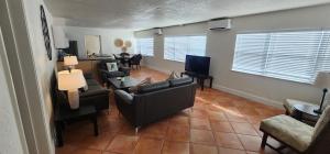 a living room with a couch and chairs and a table at By the Beach Rentals in Clearwater Beach