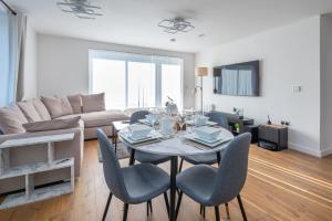 a living room with a table and chairs and a couch at The Oasis in Stonewood +10 photos