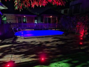 a swimming pool in a yard at night at Gwada fun habitation in Saint-Claude