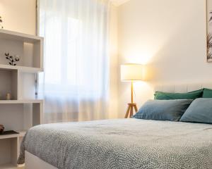 a bedroom with a large bed and a window at Castello Living in Turin