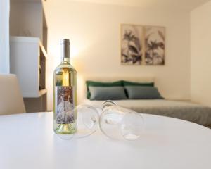 a bottle of wine sitting on a table with glasses at Castello Living in Turin