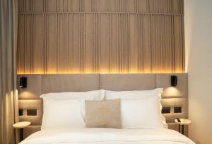 a bedroom with a large bed with white pillows at Post Inn Hotel-New Bazaar in Tirana