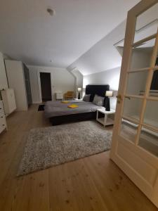 a living room with a bed and a couch at Exclusive boende Suite 2 med 4 bäddar i stort sovrum varav 2 bäddar kan stänga om sig in Frederikshavn