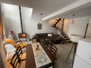 a living room with a table and a living room with a couch at Ćilibar Stara planina in Crni Vrh