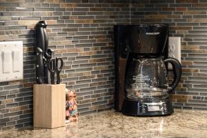 a black coffee maker on a counter next to a knife block at Trailhead Lodges Building 401 Unit 422 in Winter Park +20 photos