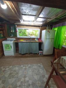 a kitchen with a sink and a refrigerator and a window at Cabaña Agustina in El Soberbio +30 photos