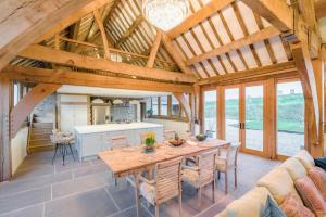 a large living room with a wooden table and chairs at 3 Bed in Dulas oc-g34082 in Longtown