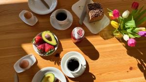 a table with plates of food and cups of coffee at Bauernhuus 6 in Fehmarn