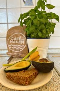 a plate of food with avocado and a potted plant at Bauernhuus 4 in Fehmarn +33 photos