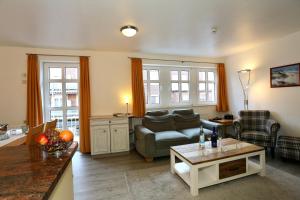 a living room with a couch and a table at Appartement 107 in Juist
