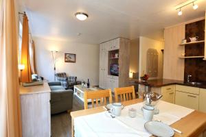 a kitchen and living room with a table and a kitchen and a dining room at Appartement 107 in Juist