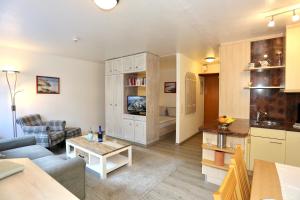 a living room with a couch and a table at Appartement 107 in Juist