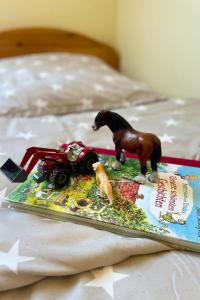a toy horse on a tray on a bed at Backhuus 1 in Fehmarn +36 photos