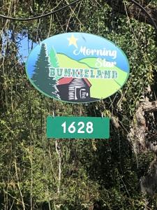 a sign for aburning signburning island with a street sign at Boho Bungalow in Nelson +35 photos