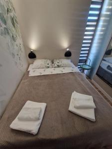 a large bed with two white towels on it at Garden of Eden- MintGarden- Sveti Vlas in Sveti Vlas +9 photos