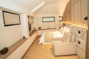 a bedroom with a bed and a couch at Post Inn Hotel-New Bazaar in Tirana